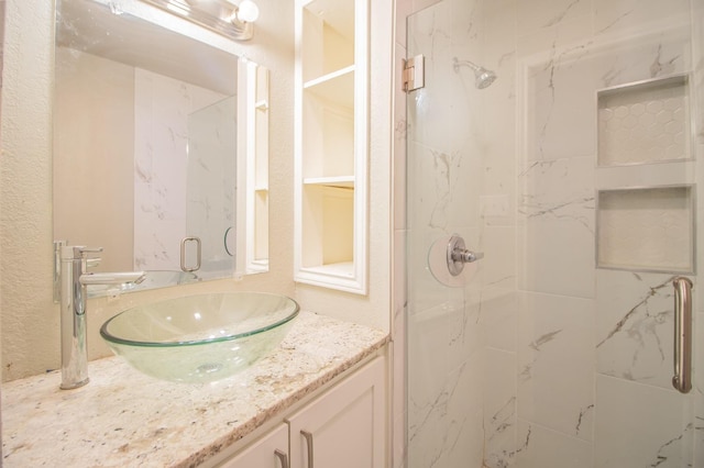 bathroom featuring walk in shower and vanity