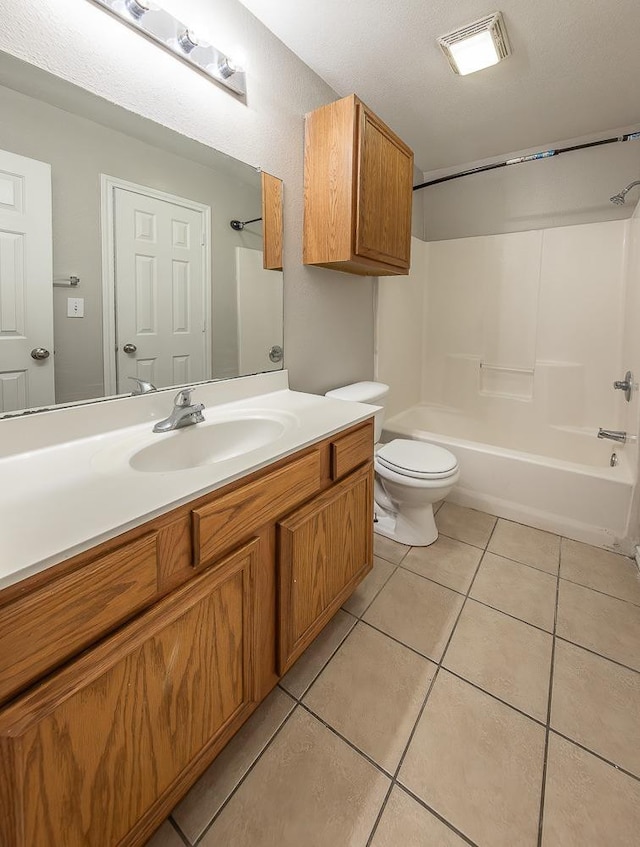 full bathroom with vanity, tile patterned floors, toilet, and washtub / shower combination