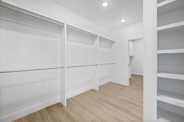 bathroom with an enclosed shower and hardwood / wood-style floors