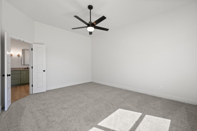 unfurnished room featuring lofted ceiling, light carpet, and ceiling fan