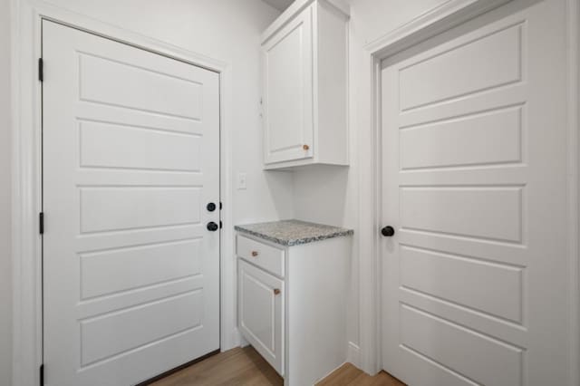 laundry room featuring light hardwood / wood-style floors