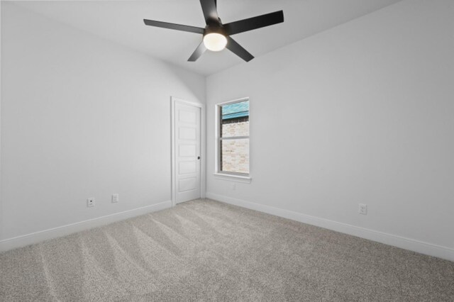 spare room with ceiling fan and carpet flooring