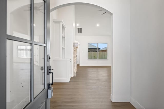 corridor with dark hardwood / wood-style flooring