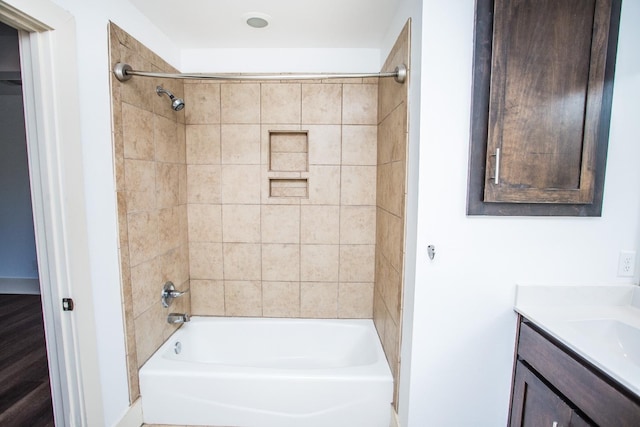 bathroom featuring vanity and tiled shower / bath