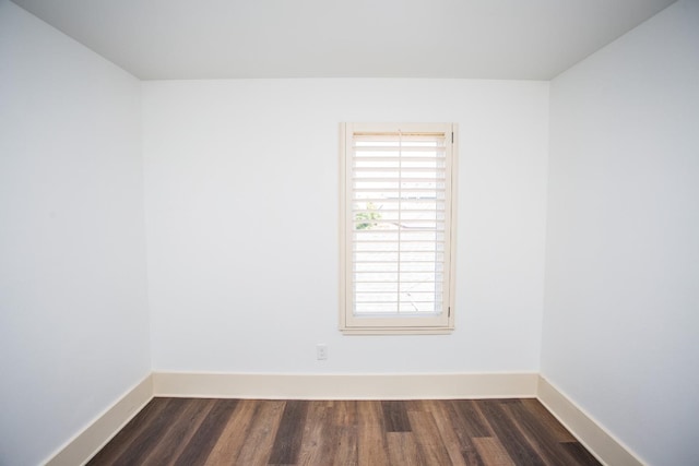 empty room featuring dark wood-type flooring