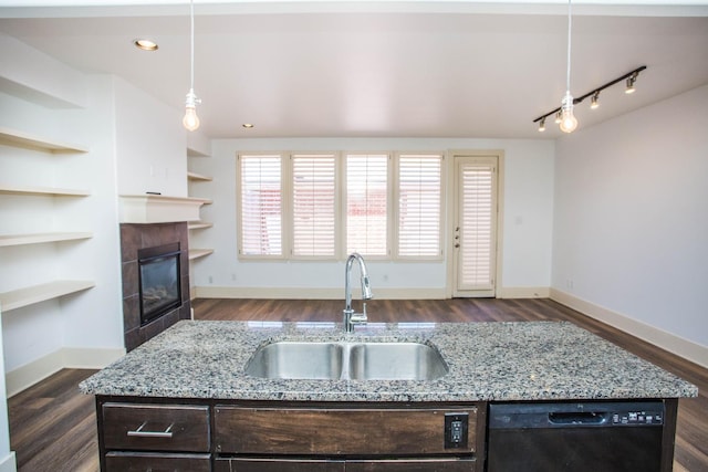 kitchen with pendant lighting, sink, dishwasher, dark brown cabinets, and light stone countertops