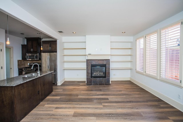 living room featuring dark hardwood / wood-style floors, sink, and a fireplace