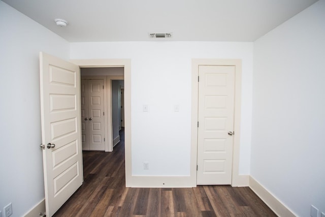 unfurnished room featuring dark hardwood / wood-style flooring