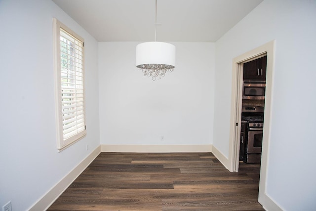 unfurnished dining area with dark wood-type flooring