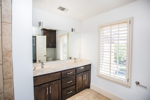 bathroom featuring vanity, toilet, and tile patterned flooring