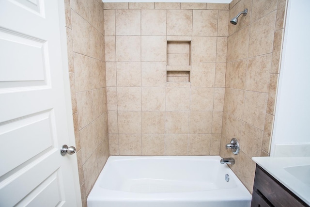 bathroom featuring vanity and tiled shower / bath