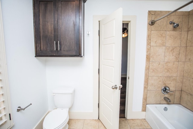 bathroom with tile patterned floors, toilet, and tiled shower / bath combo