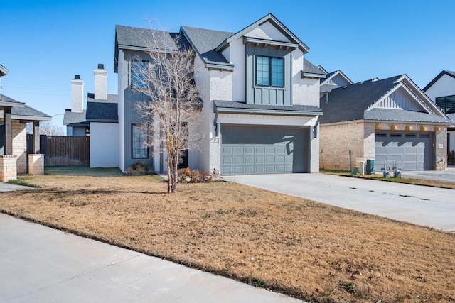 view of front of house with a front yard, an attached garage, board and batten siding, and driveway