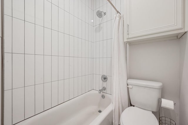 full bathroom featuring shower / bath combo with shower curtain and toilet