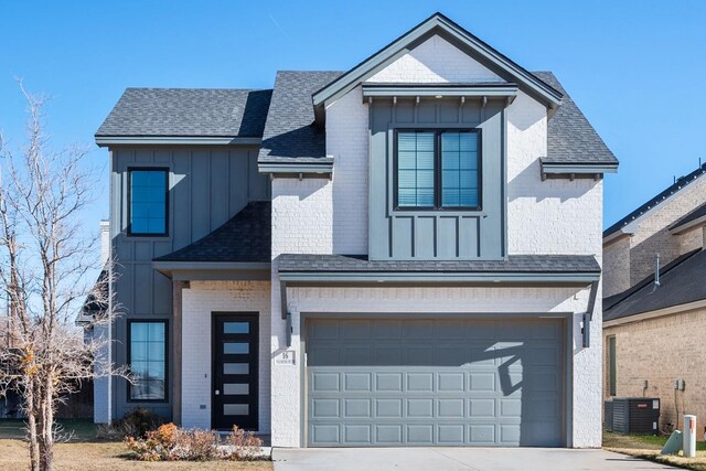 view of front of property featuring central AC unit and a garage