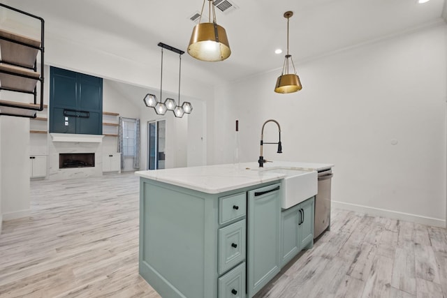 kitchen with baseboards, light wood-style floors, dishwasher, and a fireplace