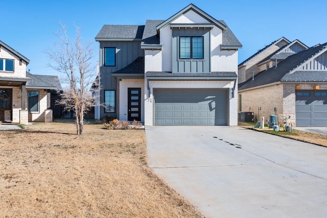 modern farmhouse with cooling unit, driveway, an attached garage, board and batten siding, and brick siding