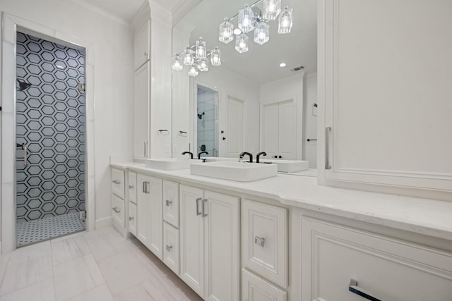 bathroom featuring double vanity, a sink, tiled shower, and ornamental molding