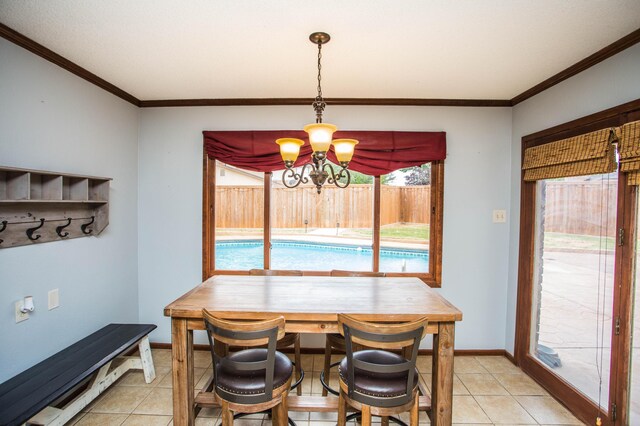 7802 Zoar Ave, Lubbock, TX 79424 - dining room with ornamental molding, a chandelier, and light tile patterned flooring