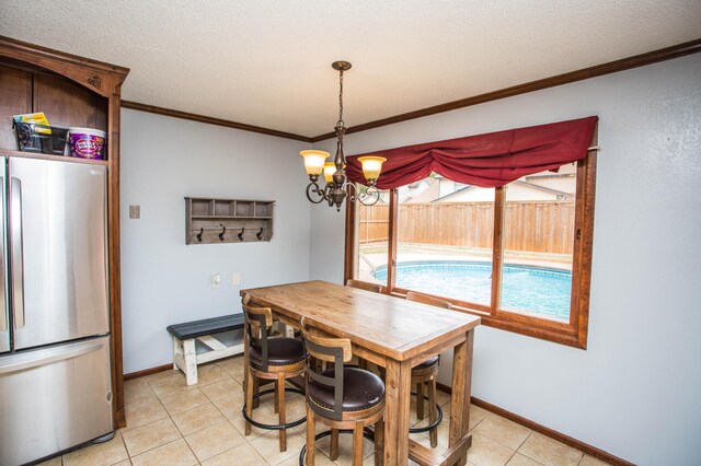 7802 Zoar Ave, Lubbock, TX 79424 - dining room with light tile patterned floors, ornamental molding, a chandelier, and a textured ceiling