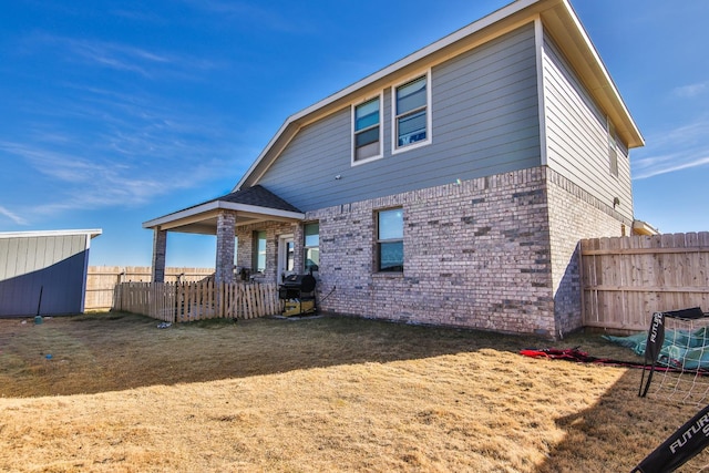 back of house featuring a yard