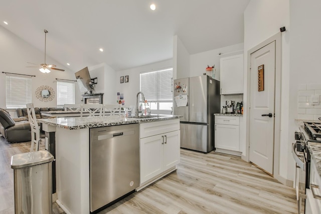 kitchen with stainless steel appliances, sink, and white cabinets