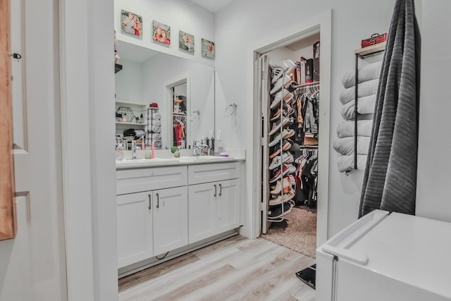 bathroom with vanity and wood-type flooring