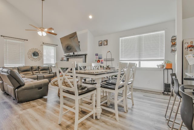 dining room with ceiling fan and light wood-type flooring