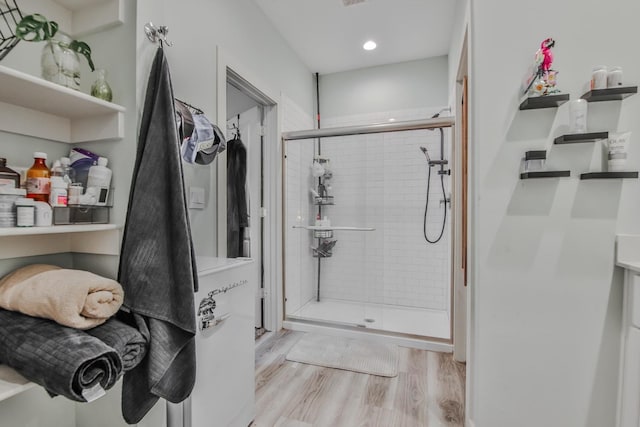 bathroom featuring walk in shower and wood-type flooring