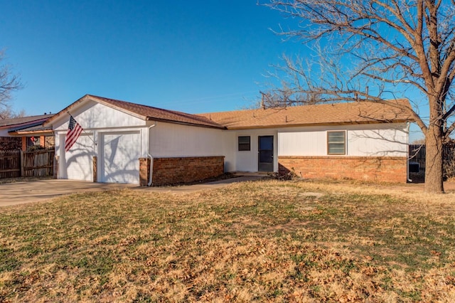 single story home featuring a garage and a front yard