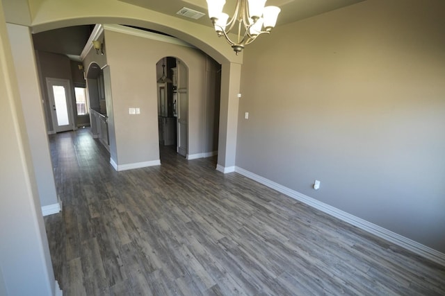 unfurnished dining area featuring an inviting chandelier and dark hardwood / wood-style floors