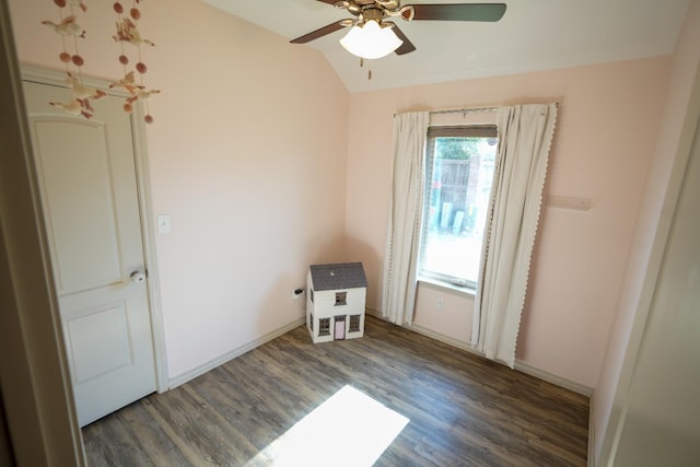 unfurnished room featuring dark wood-type flooring, ceiling fan, and lofted ceiling