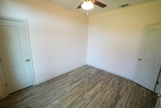 empty room with dark wood-type flooring and ceiling fan