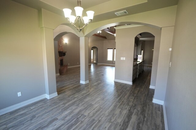 unfurnished dining area featuring a notable chandelier and dark wood-type flooring