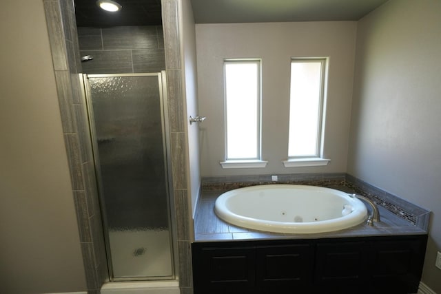 bathroom featuring shower with separate bathtub