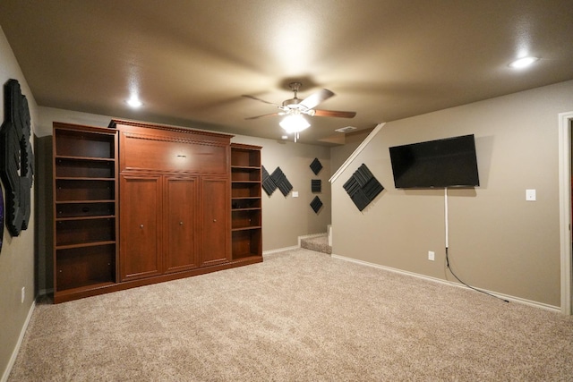 interior space with carpet flooring and ceiling fan