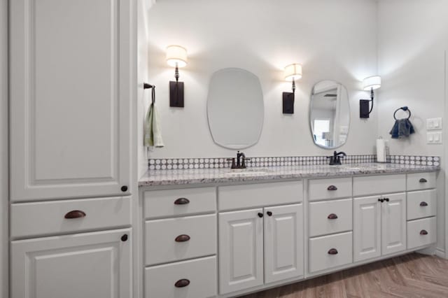 bathroom with parquet floors and vanity