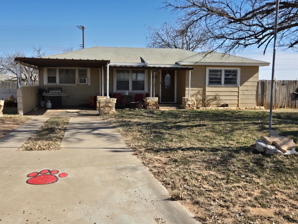 view of front facade with cooling unit and a front yard