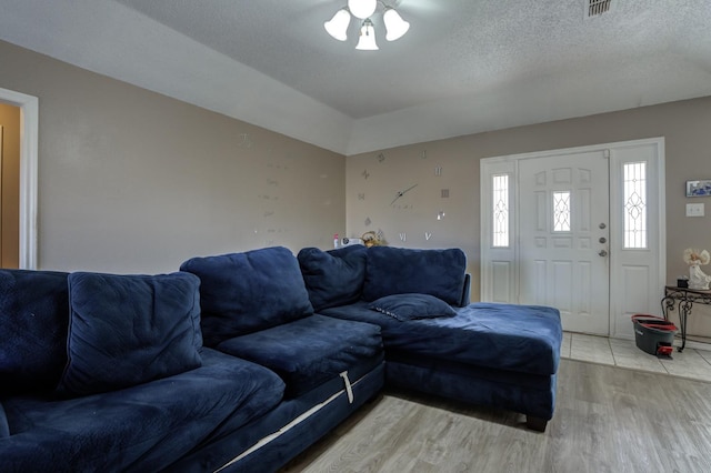 living room featuring light hardwood / wood-style floors and a textured ceiling