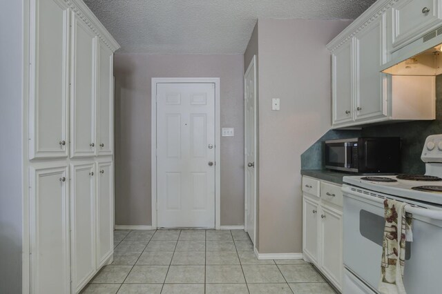 kitchen featuring light tile patterned flooring, custom range hood, white electric range, and white cabinets