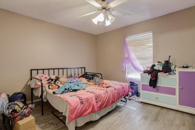 bedroom with ceiling fan and light hardwood / wood-style flooring