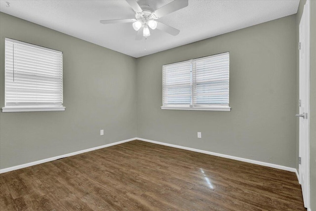 4802 54th St, Lubbock, TX 79414 - empty room featuring dark wood-style flooring, baseboards, and a ceiling fan
