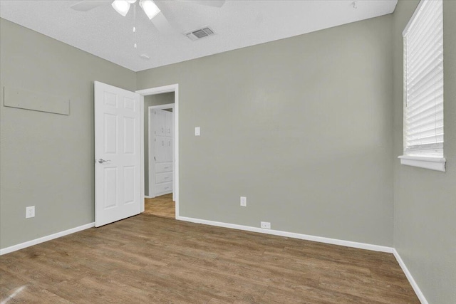 4802 54th St, Lubbock, TX 79414 - unfurnished bedroom with wood finished floors, baseboards, and a ceiling fan