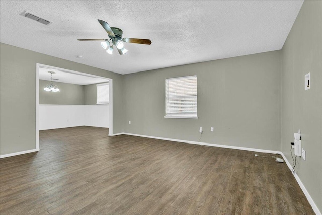 4802 54th St, Lubbock, TX 79414 - spare room with ceiling fan, dark wood finished floors, a chandelier, a textured ceiling, and baseboards