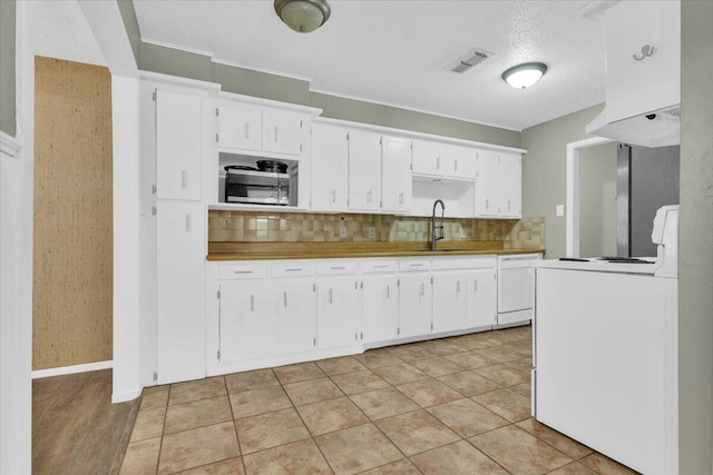 4802 54th St, Lubbock, TX 79414 - kitchen with a sink, stove, white dishwasher, decorative backsplash, and white cabinets