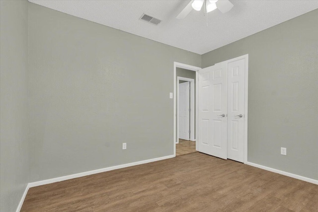 4802 54th St, Lubbock, TX 79414 - unfurnished bedroom with wood finished floors, baseboards, and ceiling fan