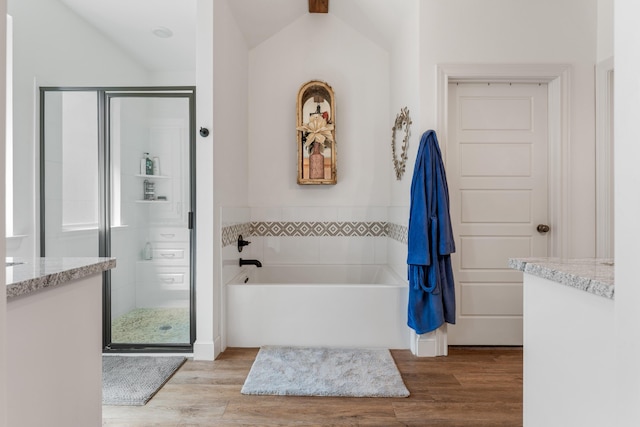 full bathroom with a garden tub, wood finished floors, and a stall shower