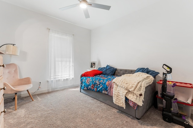 carpeted bedroom featuring ceiling fan and baseboards