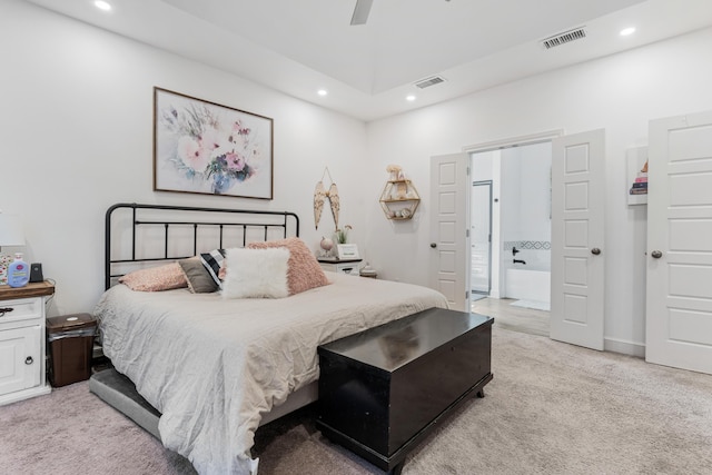 bedroom featuring recessed lighting, light carpet, visible vents, and ensuite bathroom