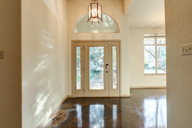 foyer entrance with a notable chandelier